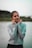 a woman standing next to a body of water