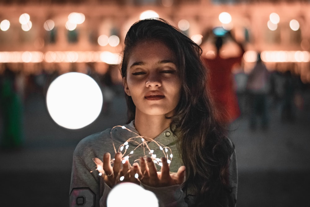 a woman holding a crystal ball in her hands