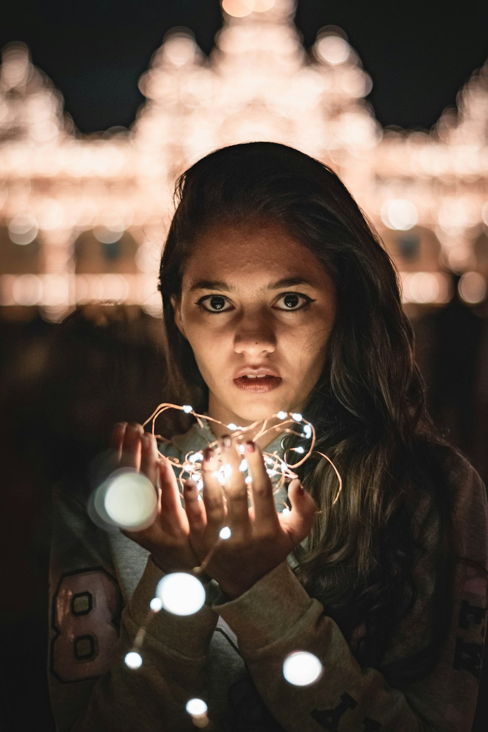 a woman holding a pair of glasses in her hands