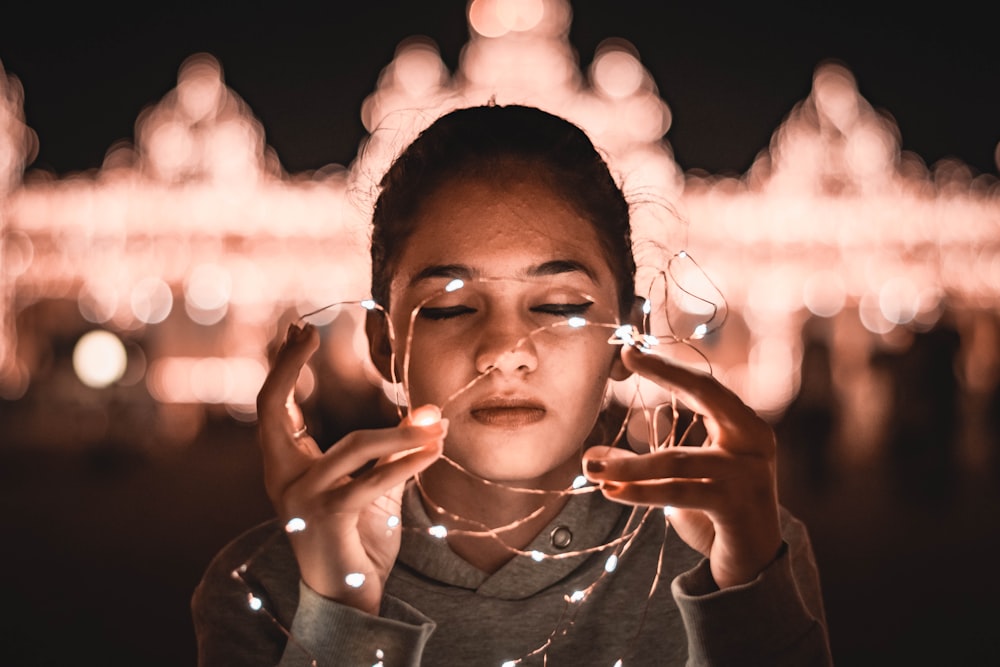 a woman holding a glass in front of her face