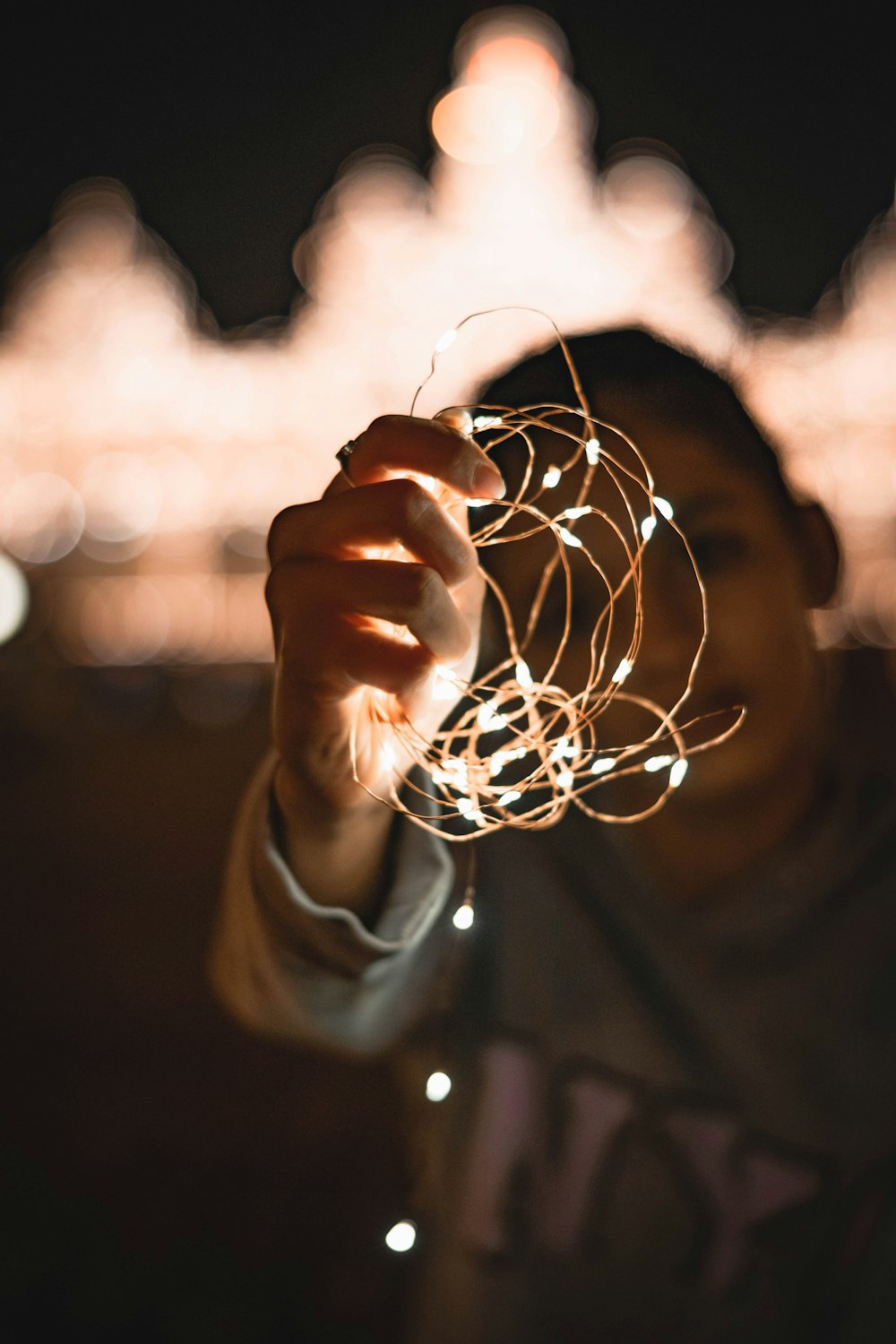 a person holding a string of lights in their hand