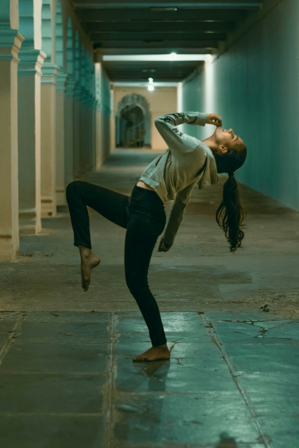 a woman doing a handstand in a hallway