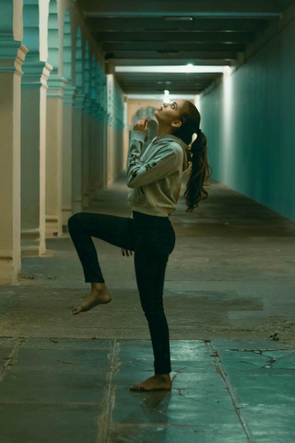 a woman standing in the middle of a hallway