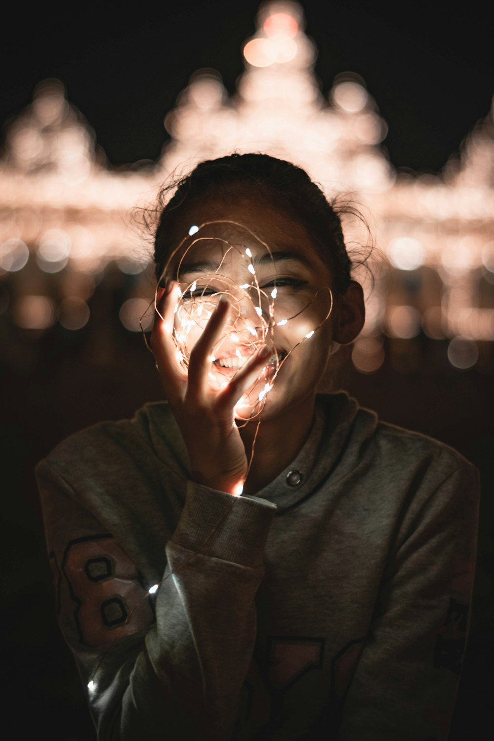 a young girl holding her hands to her face