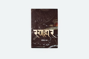 A book cover with an intricate, dark design featuring metallic elements and chains. Text appears in a bold, stylized font.