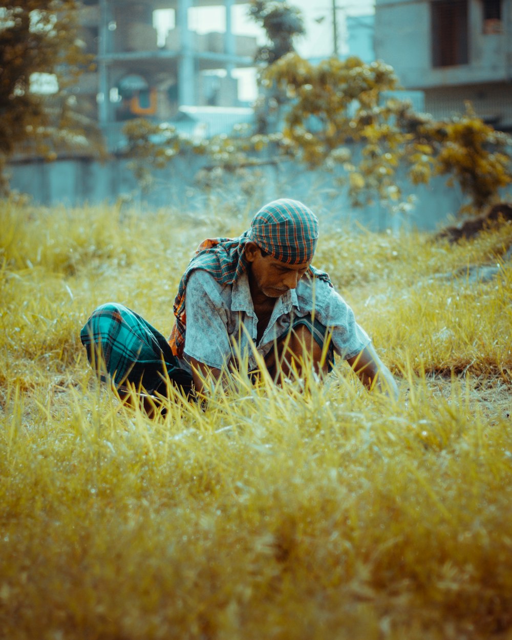 a person sitting in a field of tall grass