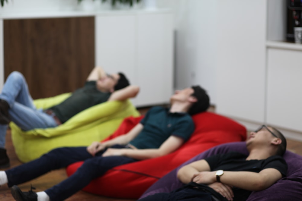 a group of people laying on bean bag chairs