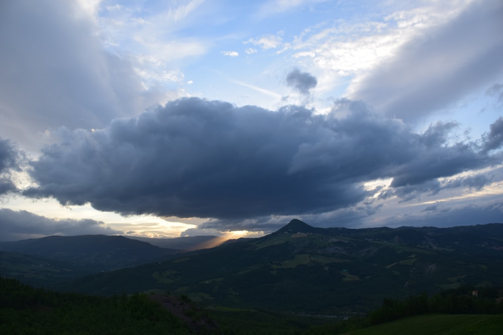 a view of a mountain range under a cloudy sky