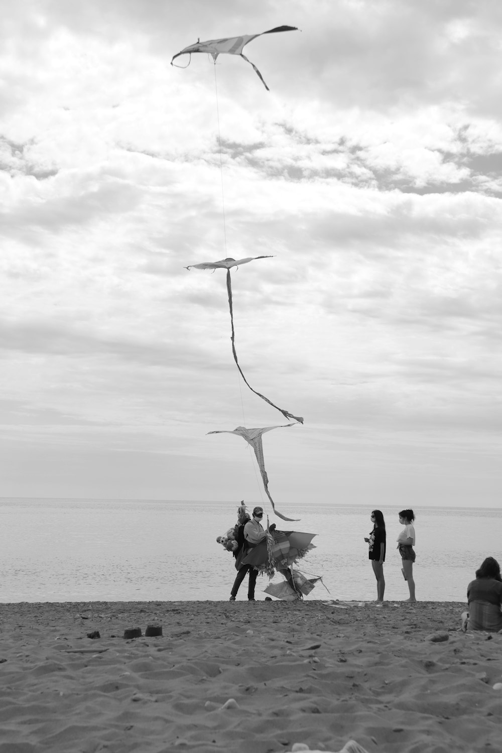 a group of people standing on top of a sandy beach