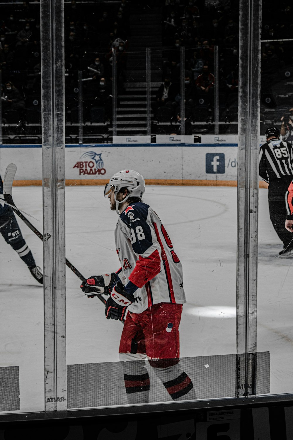 a hockey player standing in front of a mirror