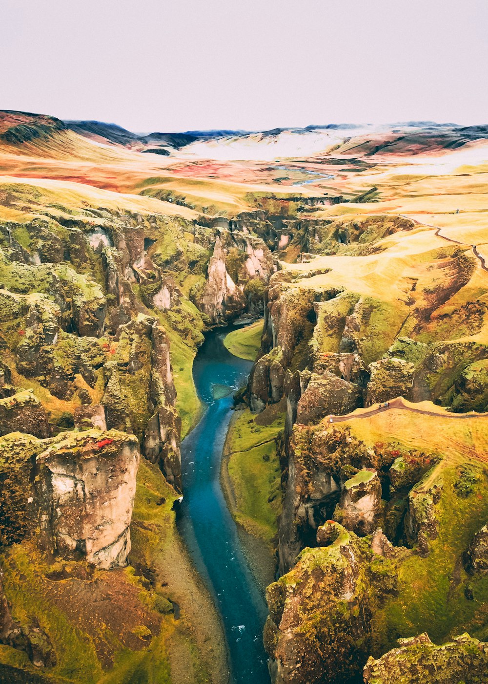 a river running through a lush green valley