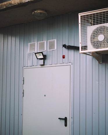 a wall mounted air conditioner next to a door