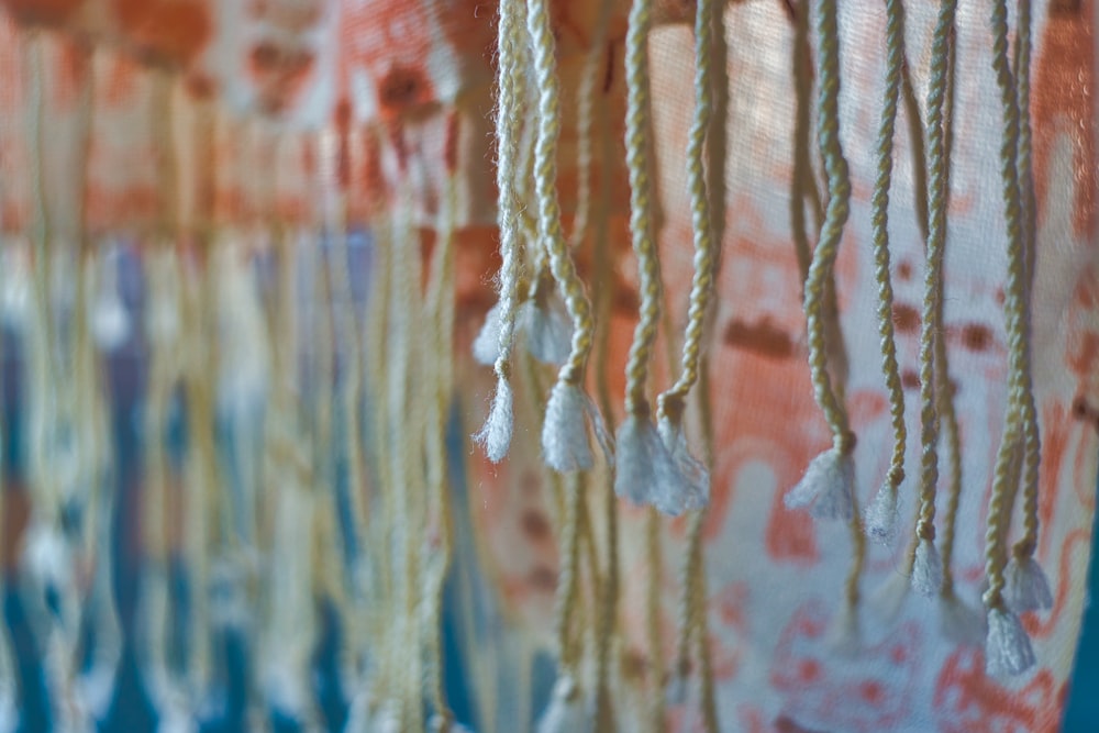 a close up of a curtain with beads hanging from it