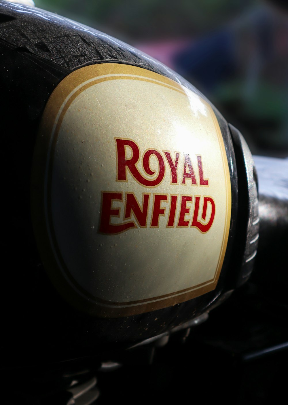 a close up of the royal enfield logo on a motorcycle