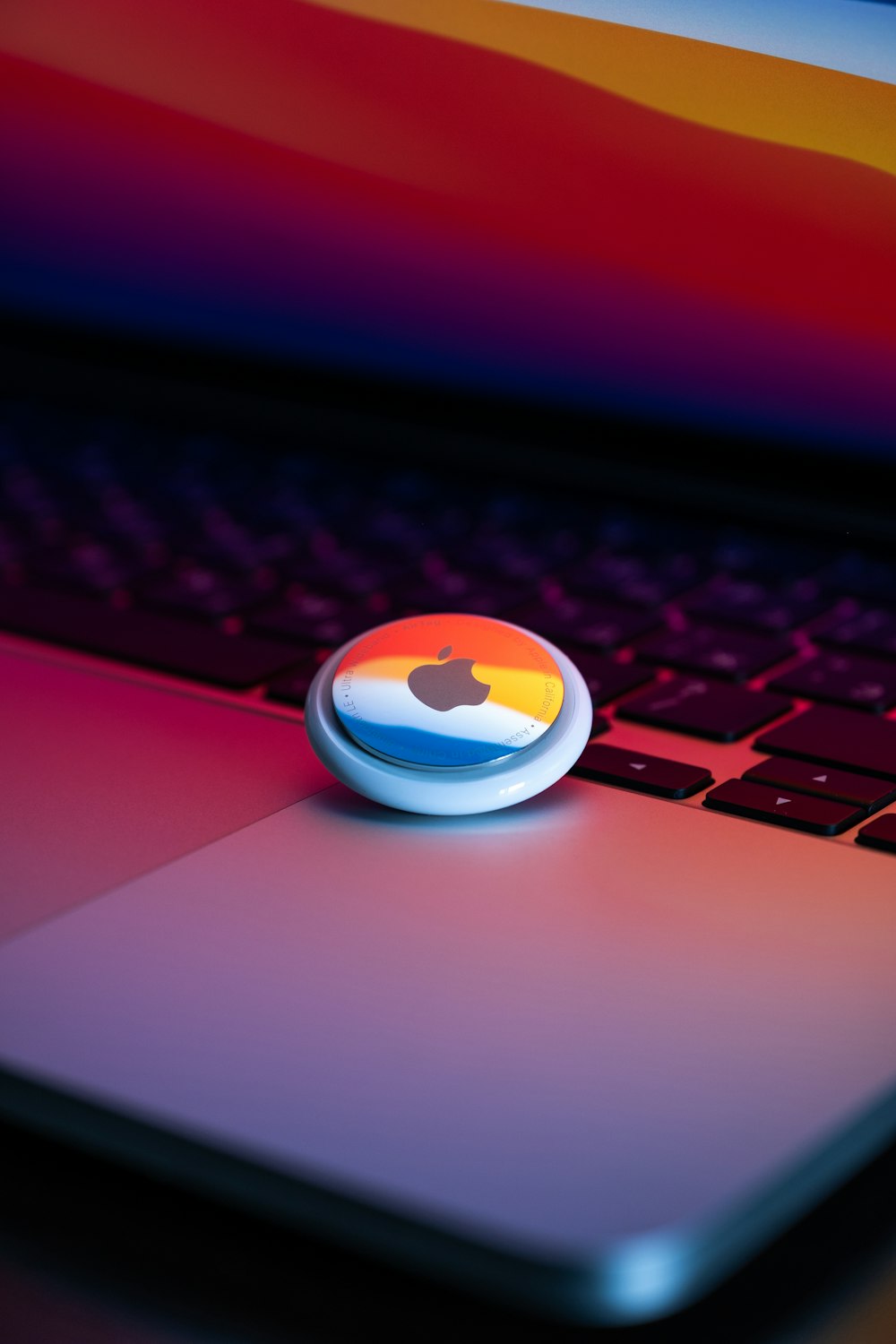 a close up of an apple logo on a laptop