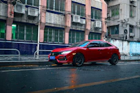a red car parked on the side of the road