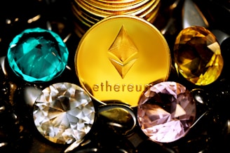 a close up of a gold coin surrounded by other jewels