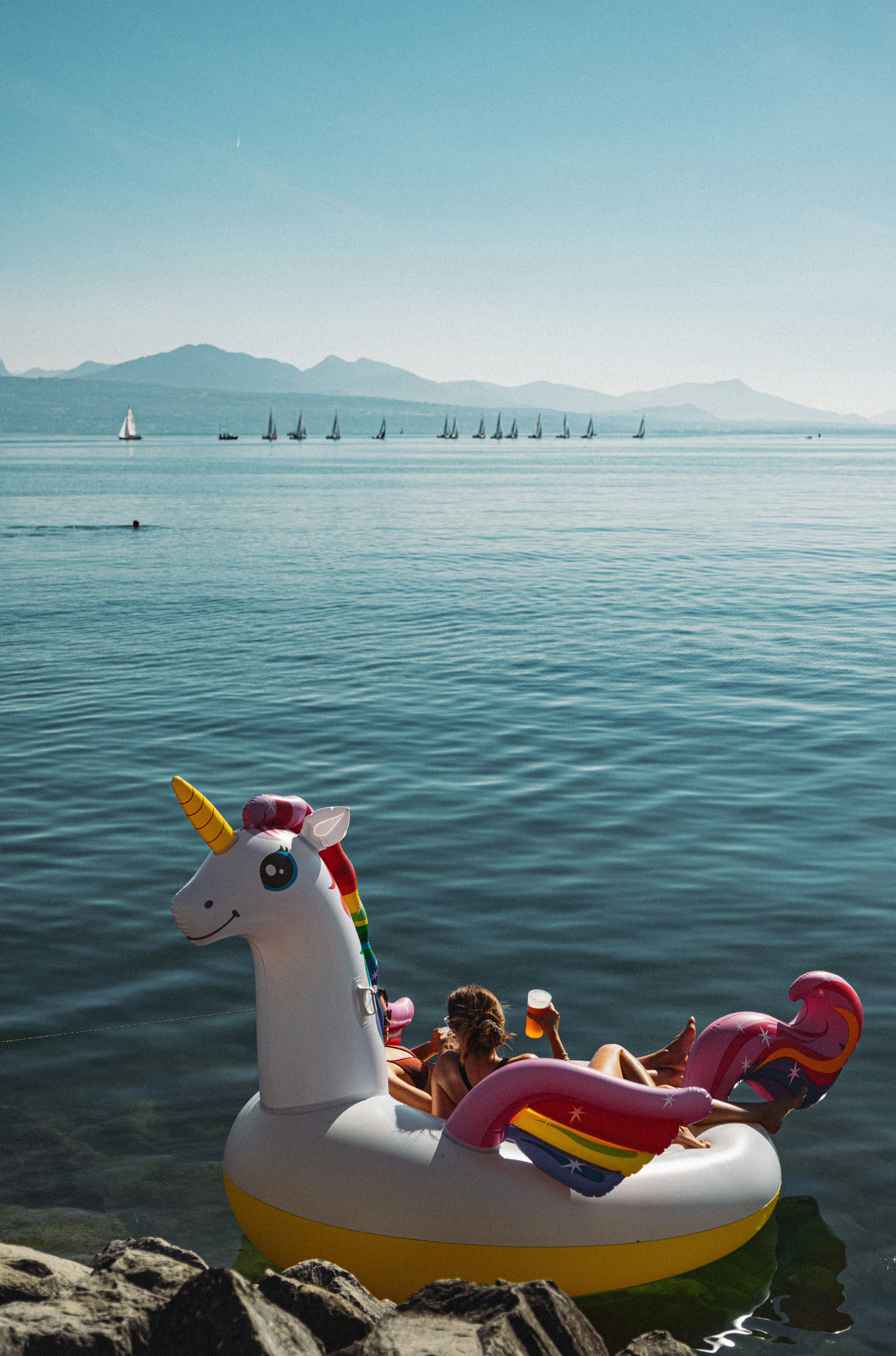 an inflatable unicorn float floating on the water