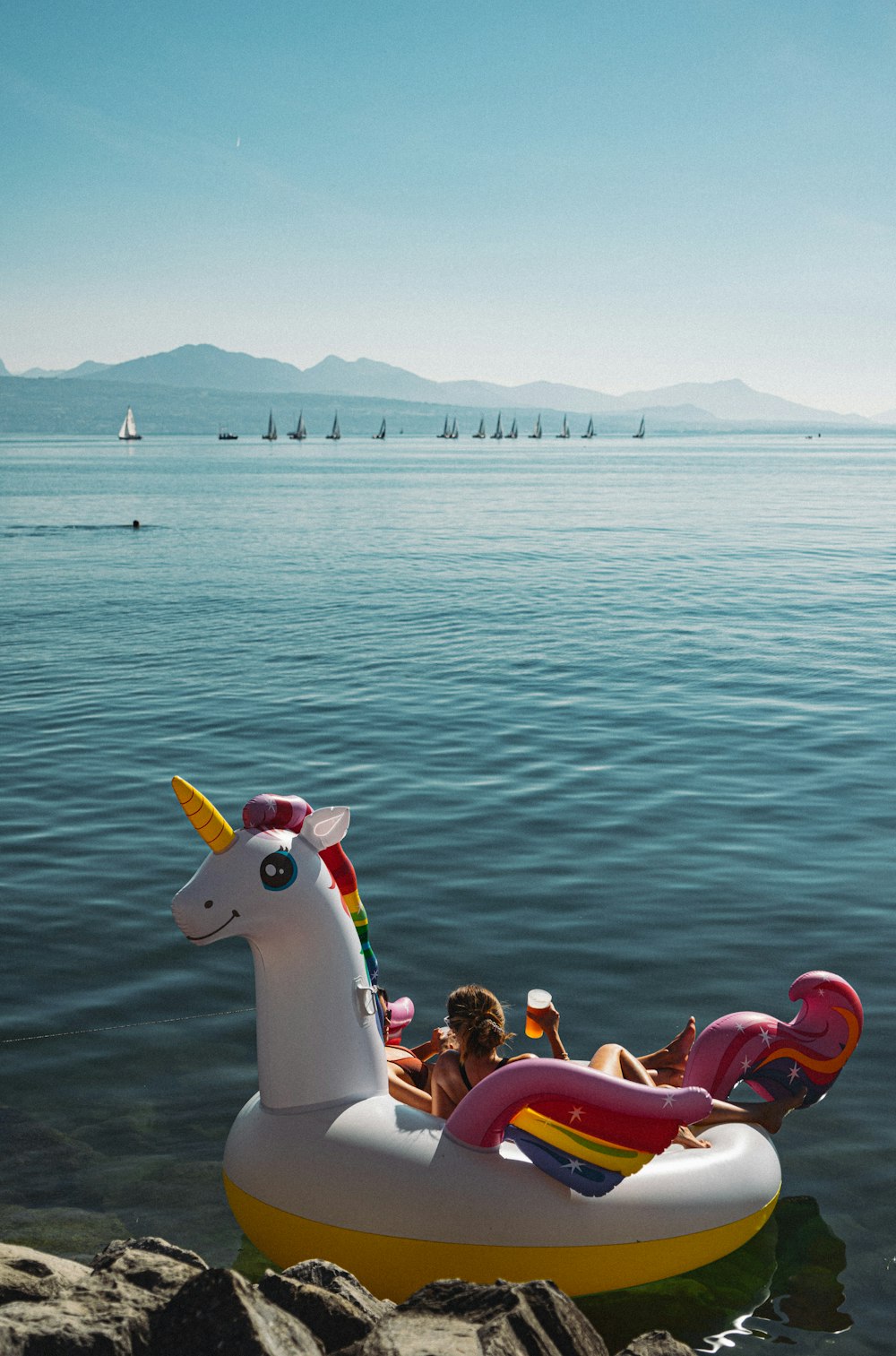 an inflatable unicorn float floating on the water