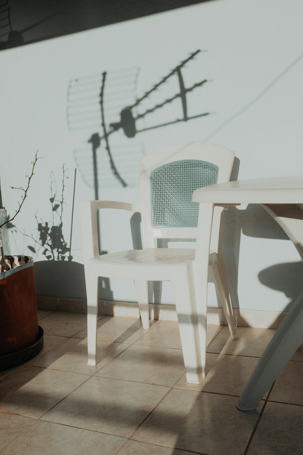 white plastic chairs beside white table