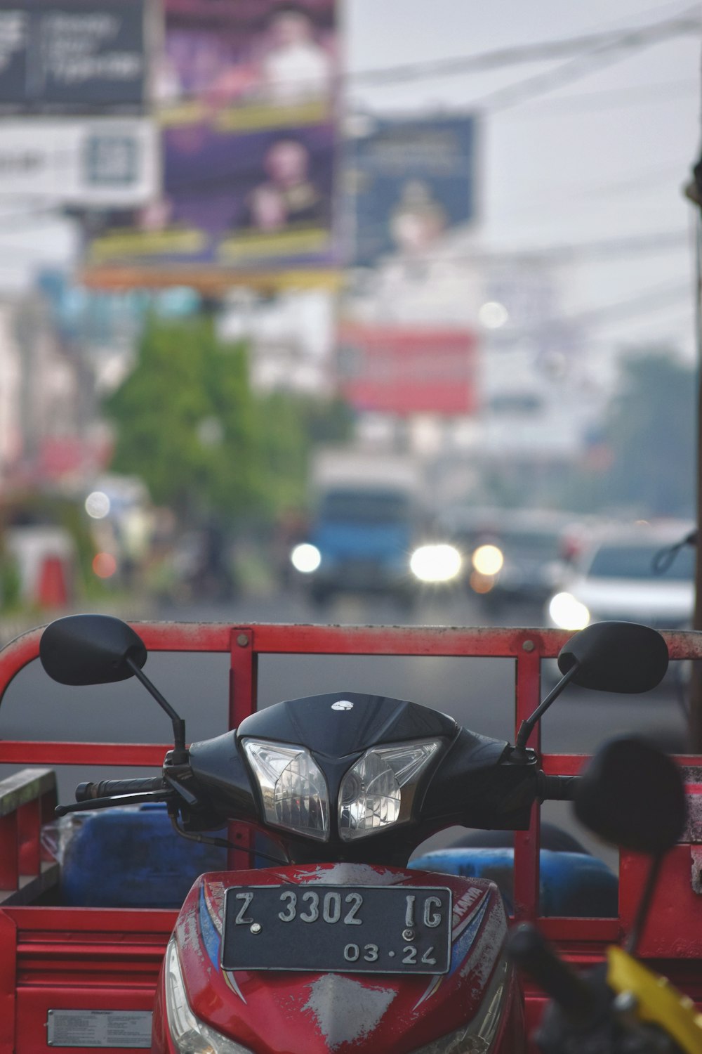 a red motorcycle parked in front of a red truck