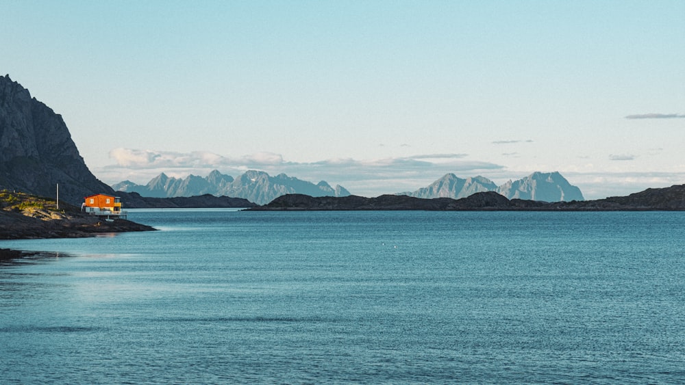 a body of water with mountains in the background