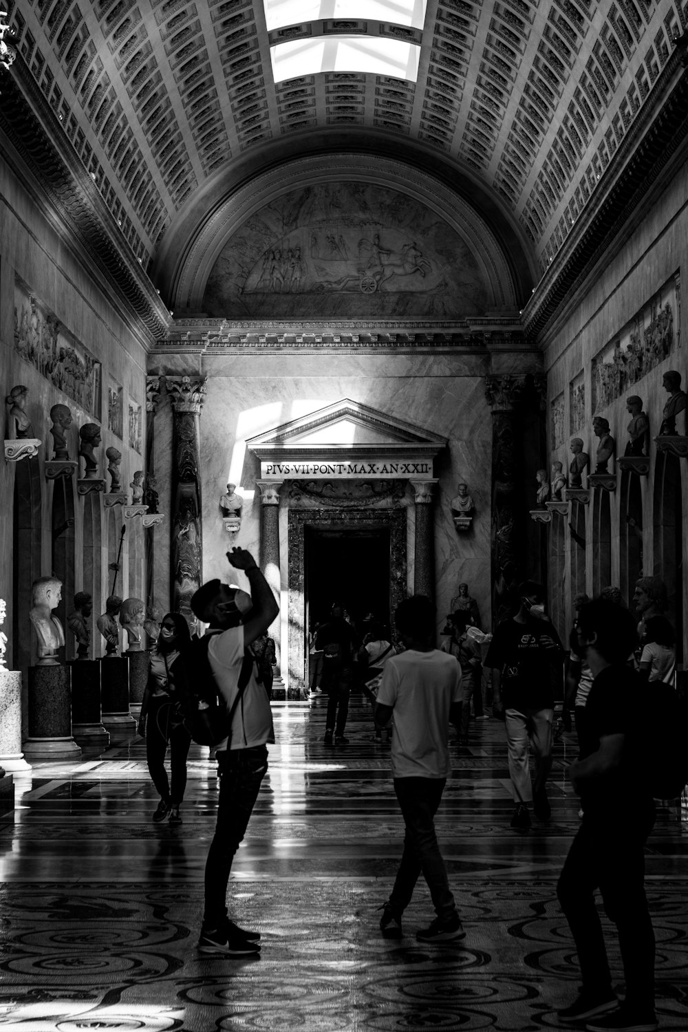 a black and white photo of people in a building