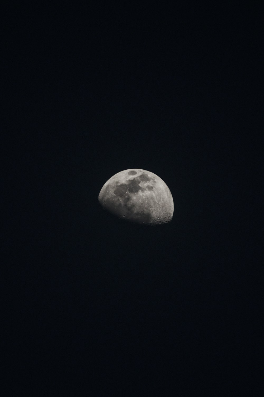 a full moon in the sky with a dark background