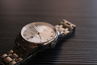 Close-up of a men's premium bracelet resting on a sleek black surface with subtle lighting highlighting its craftsmanship.