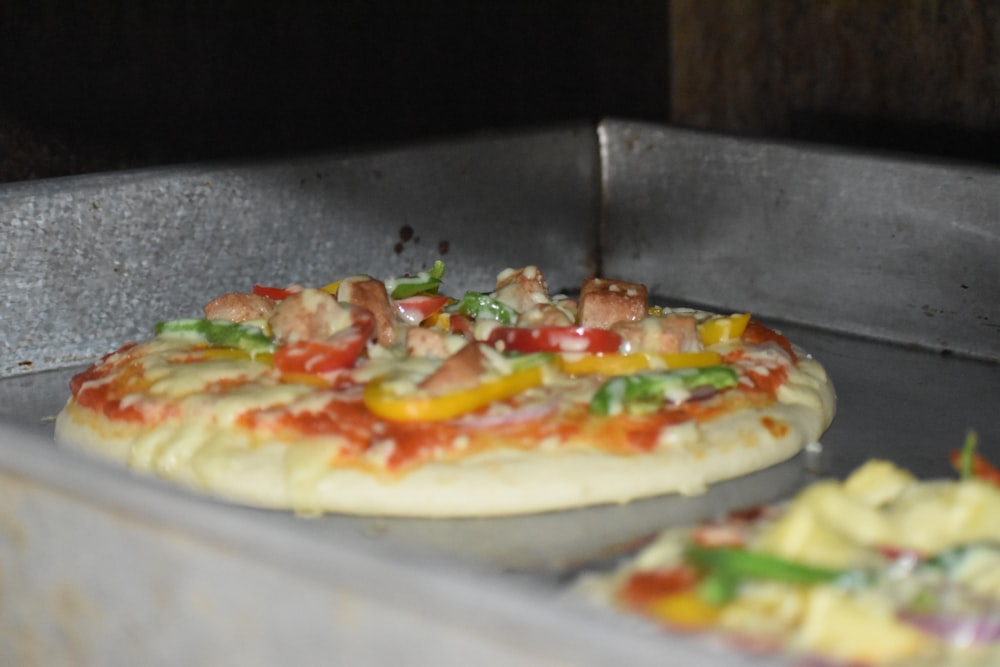 a pizza sitting on top of a metal pan