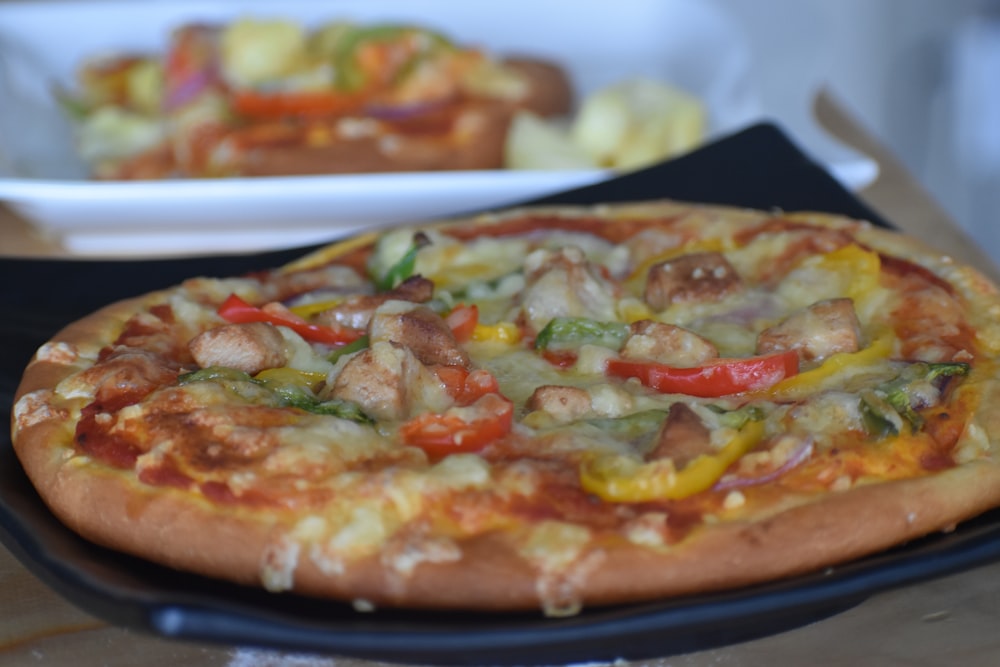 a pizza sitting on top of a pan on top of a table