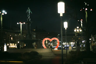 A comforting nighttime urban scene with a glowing digital heart symbolizing emotional support.