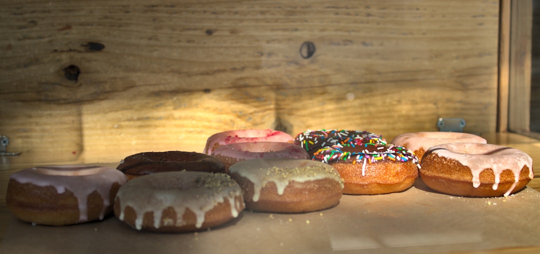 a bunch of doughnuts that are on a table, Moody locally made vegan donuts in glass display glass display at Steelhead co