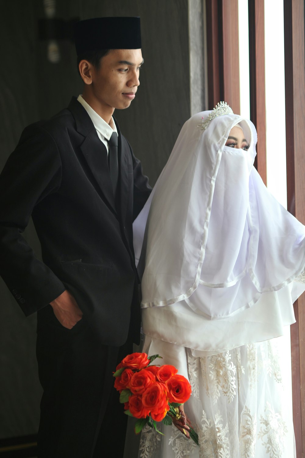a man and a woman dressed in wedding attire