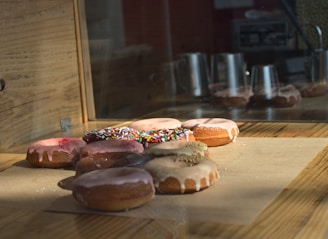 A beautifully arranged display of donuts on a wooden table.