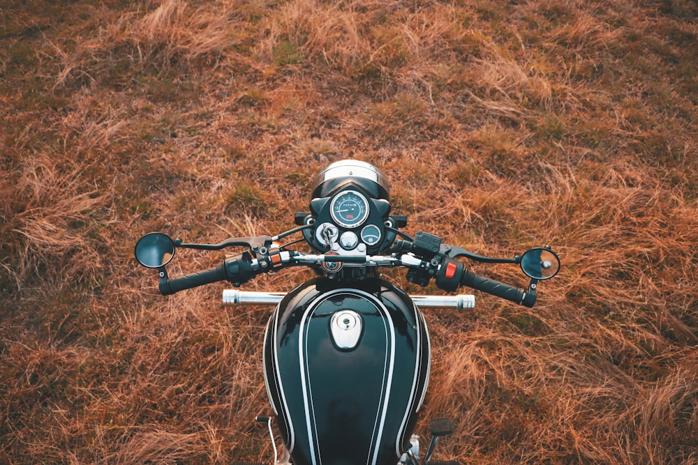 a motorcycle parked in a field of brown grass