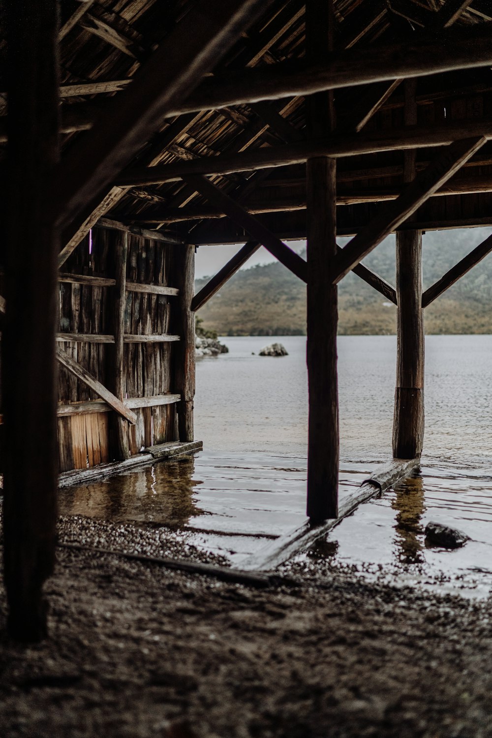 a wooden structure sitting on top of a body of water