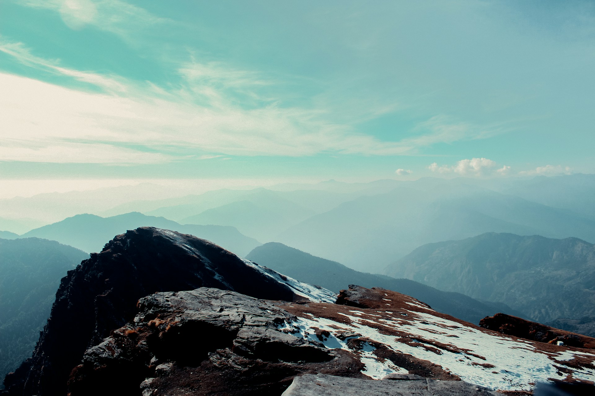 a person standing on top of a snow covered mountain