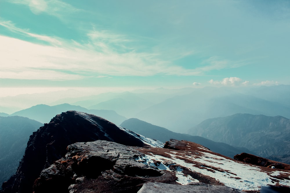 a person standing on top of a snow covered mountain