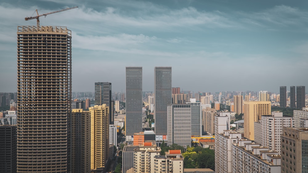 a city with tall buildings and a crane in the sky