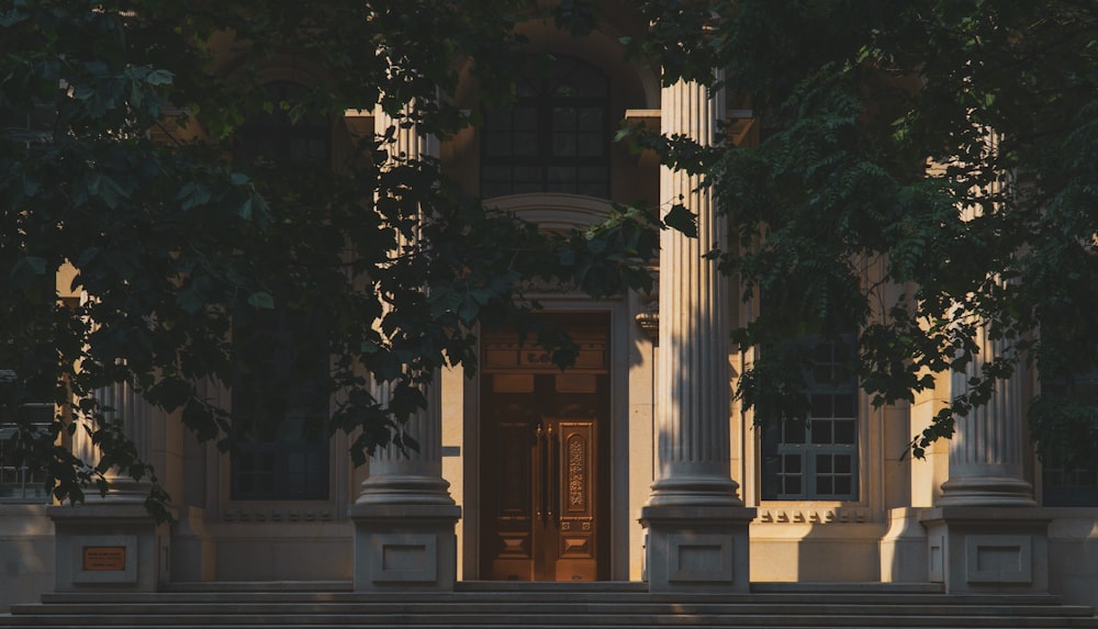 a building with columns and a bench in front of it