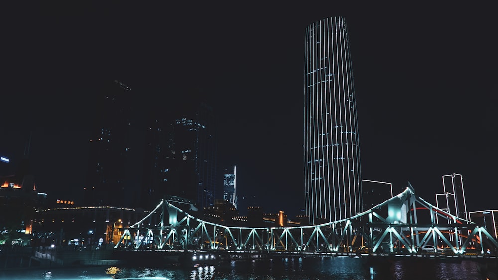 a large bridge over a river next to a tall building