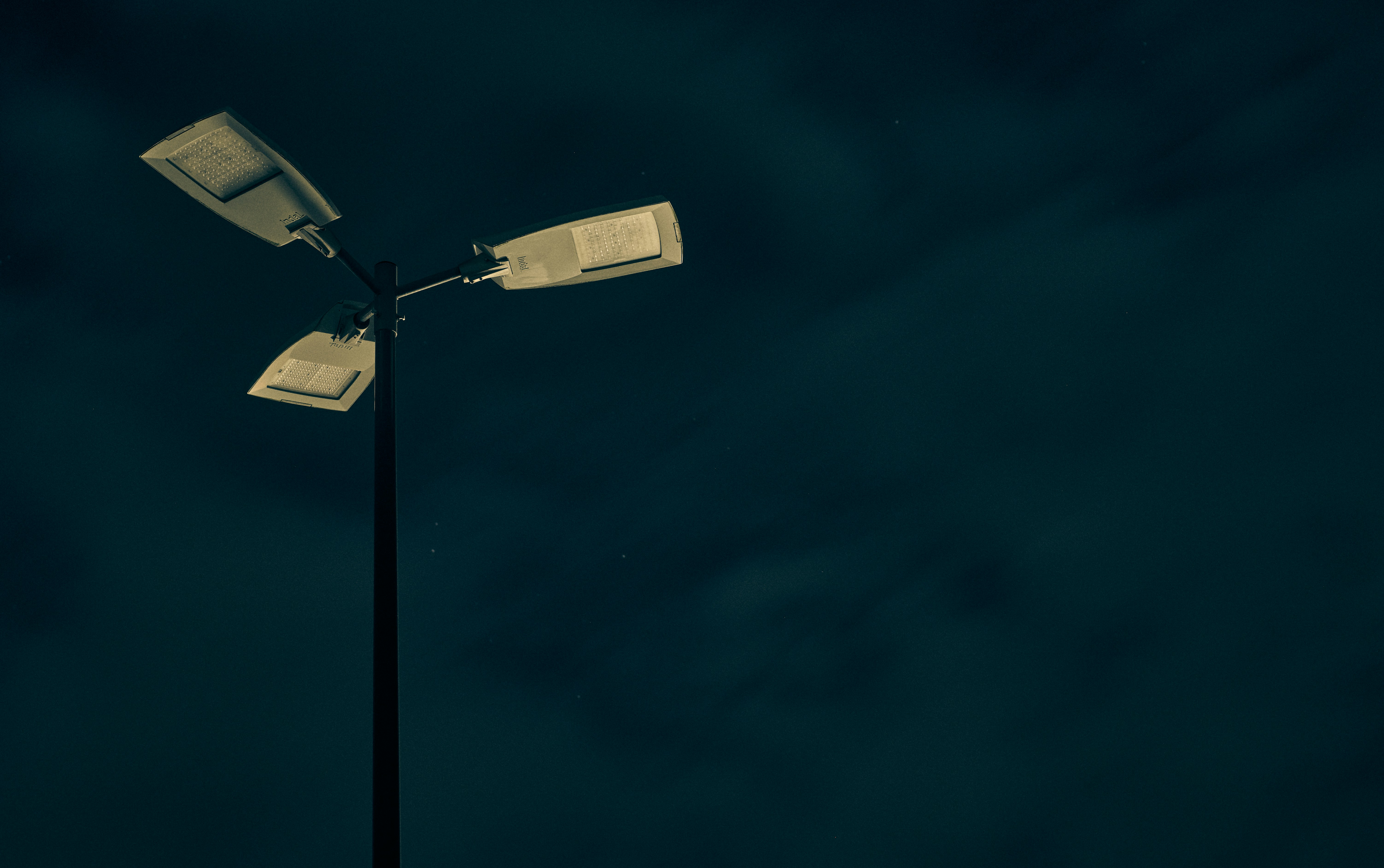 a street light in the dark with a sky background