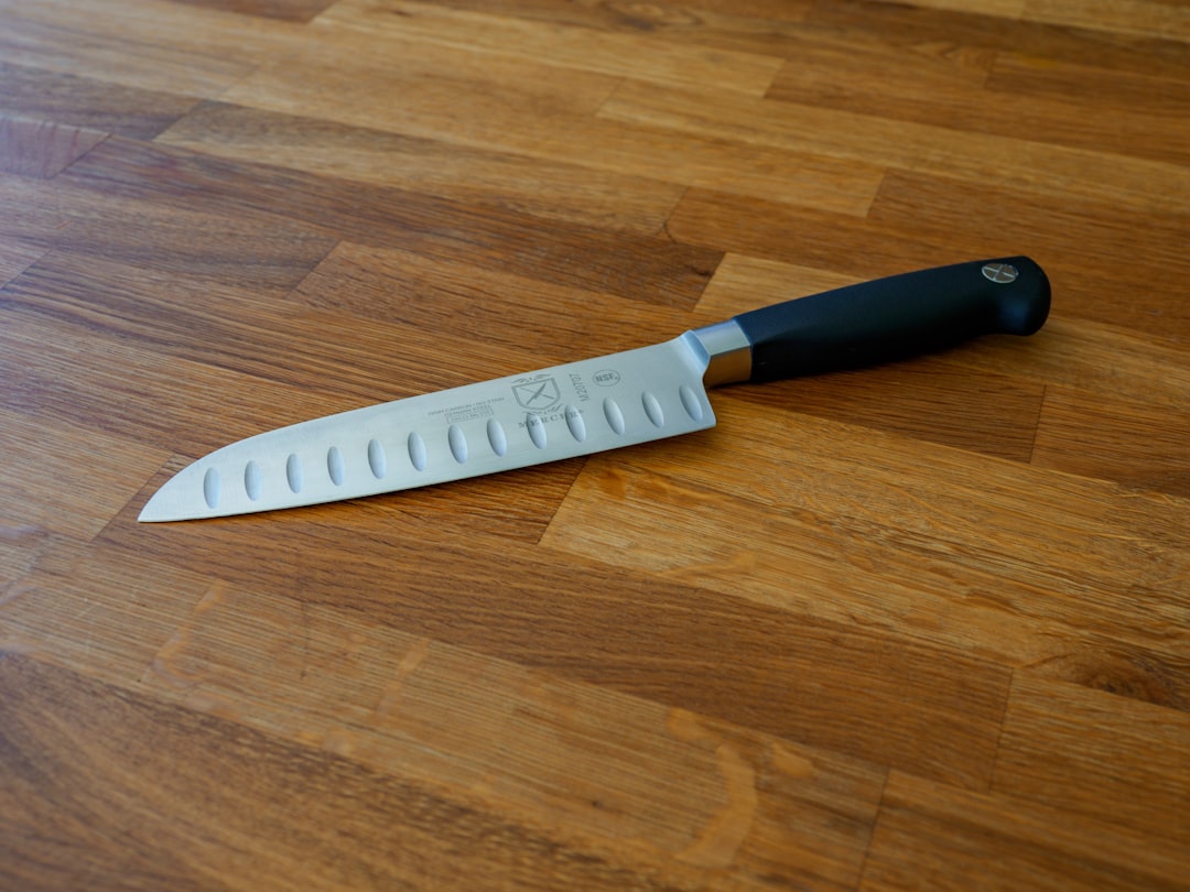 black handled knife on brown wooden table