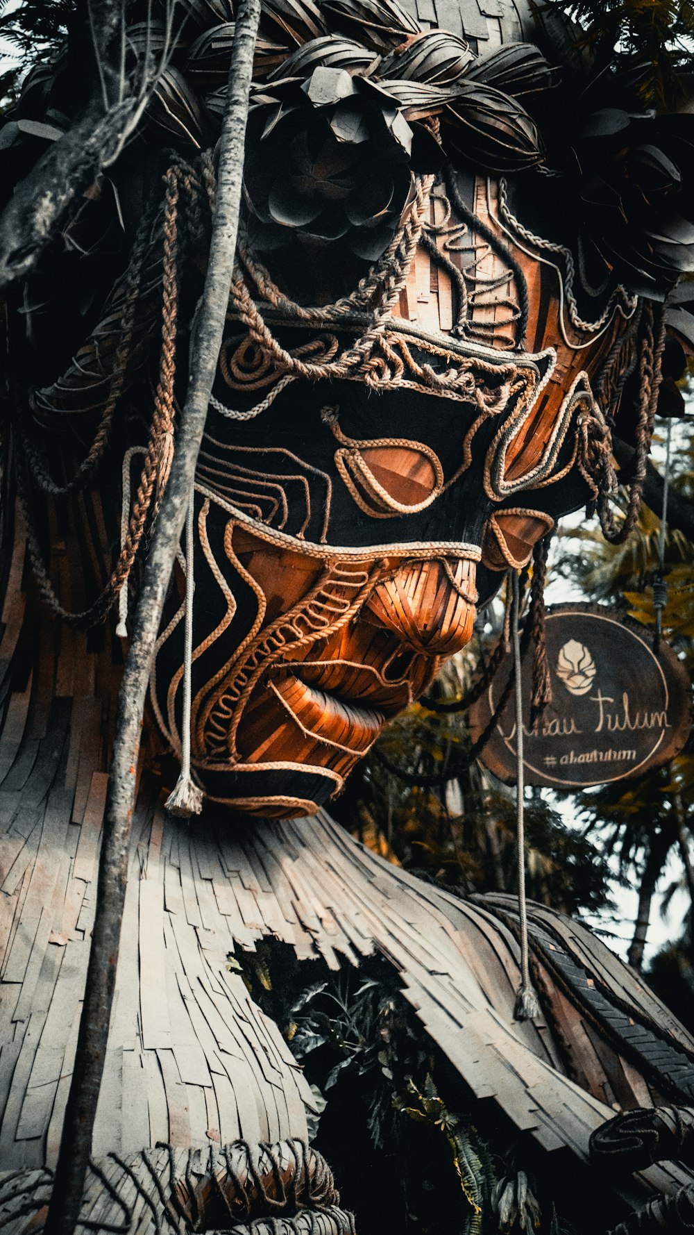 a close up of a mask on a tree
