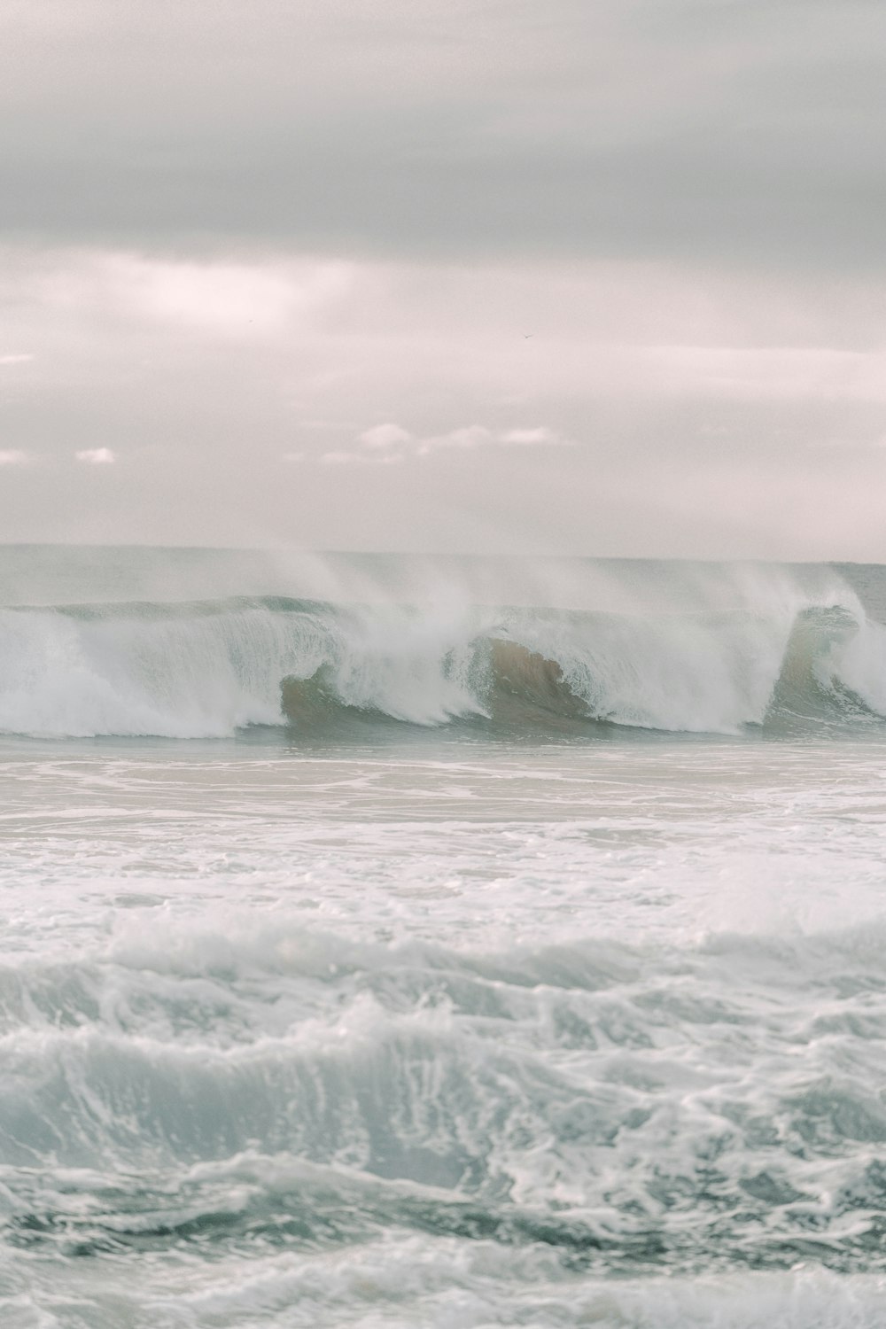 a man riding a surfboard on top of a wave in the ocean