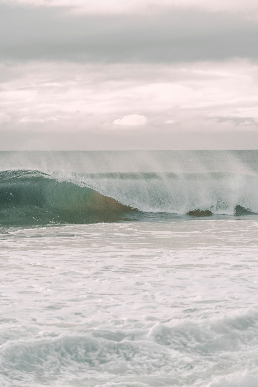 a person riding a surfboard on a wave in the ocean