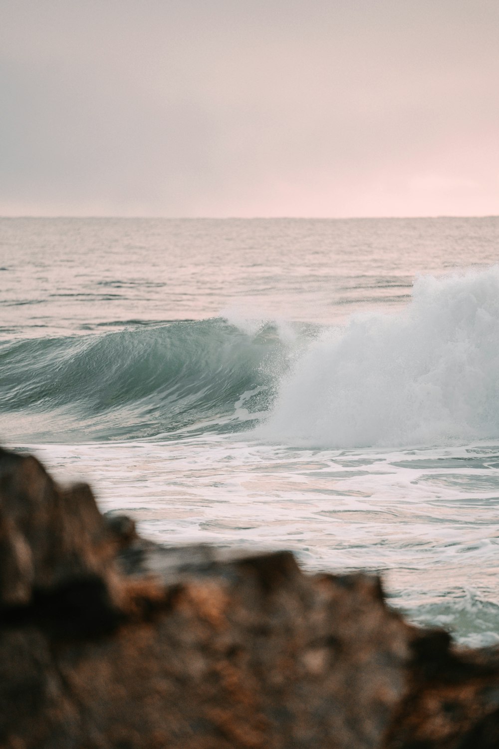 a man riding a wave on top of a surfboard