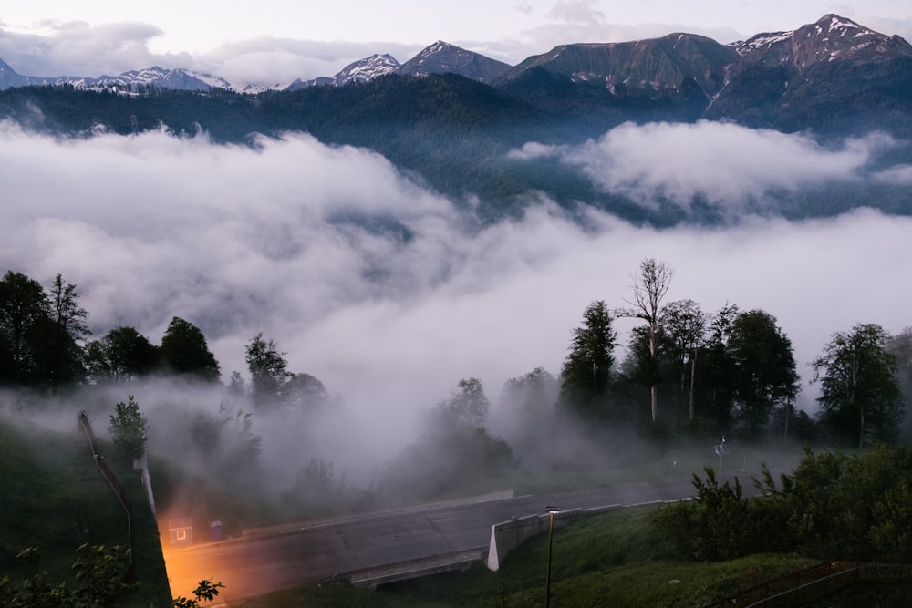 a road in the middle of a mountain covered in fog