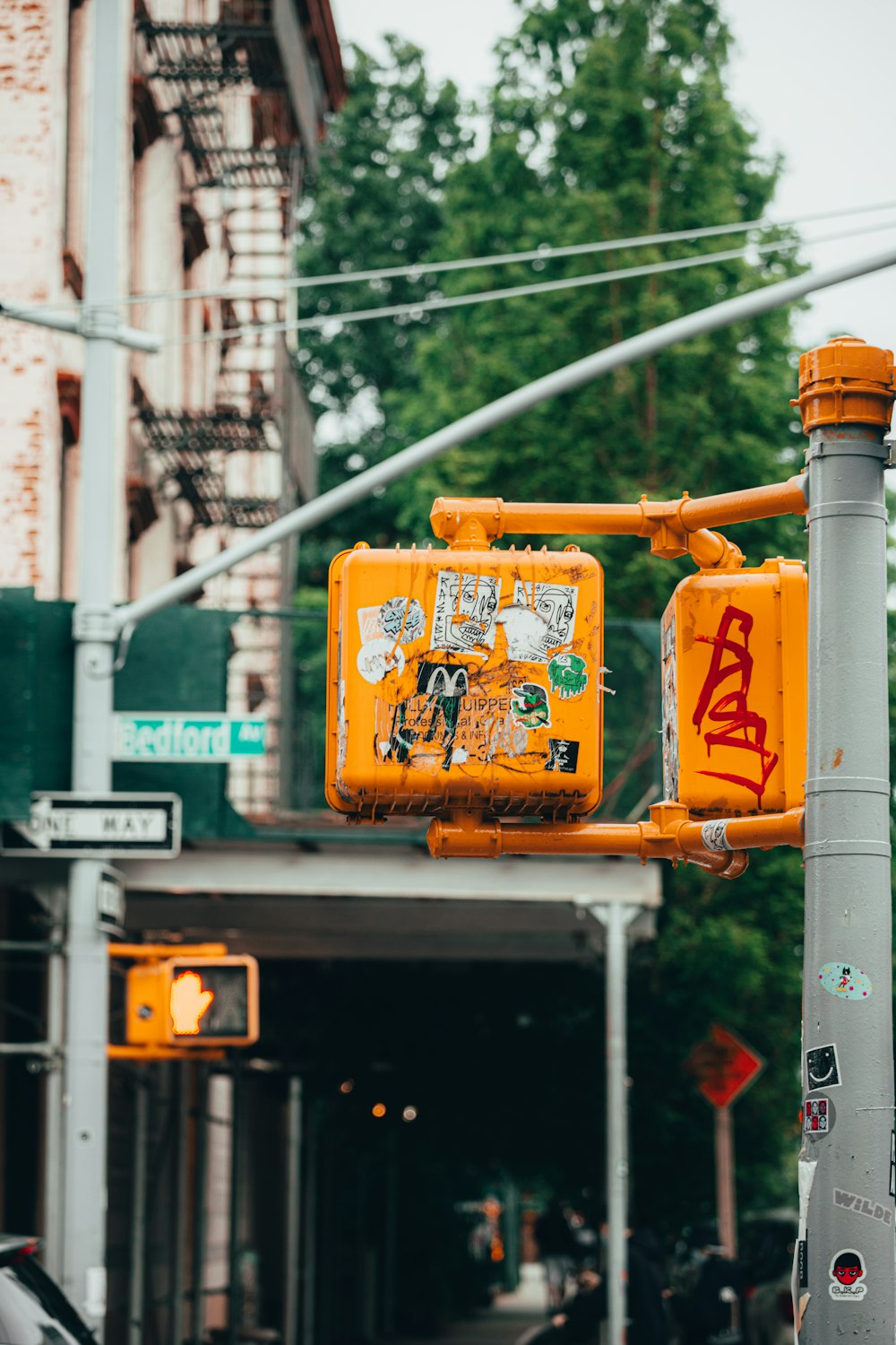 a yellow traffic light sitting on the side of a road